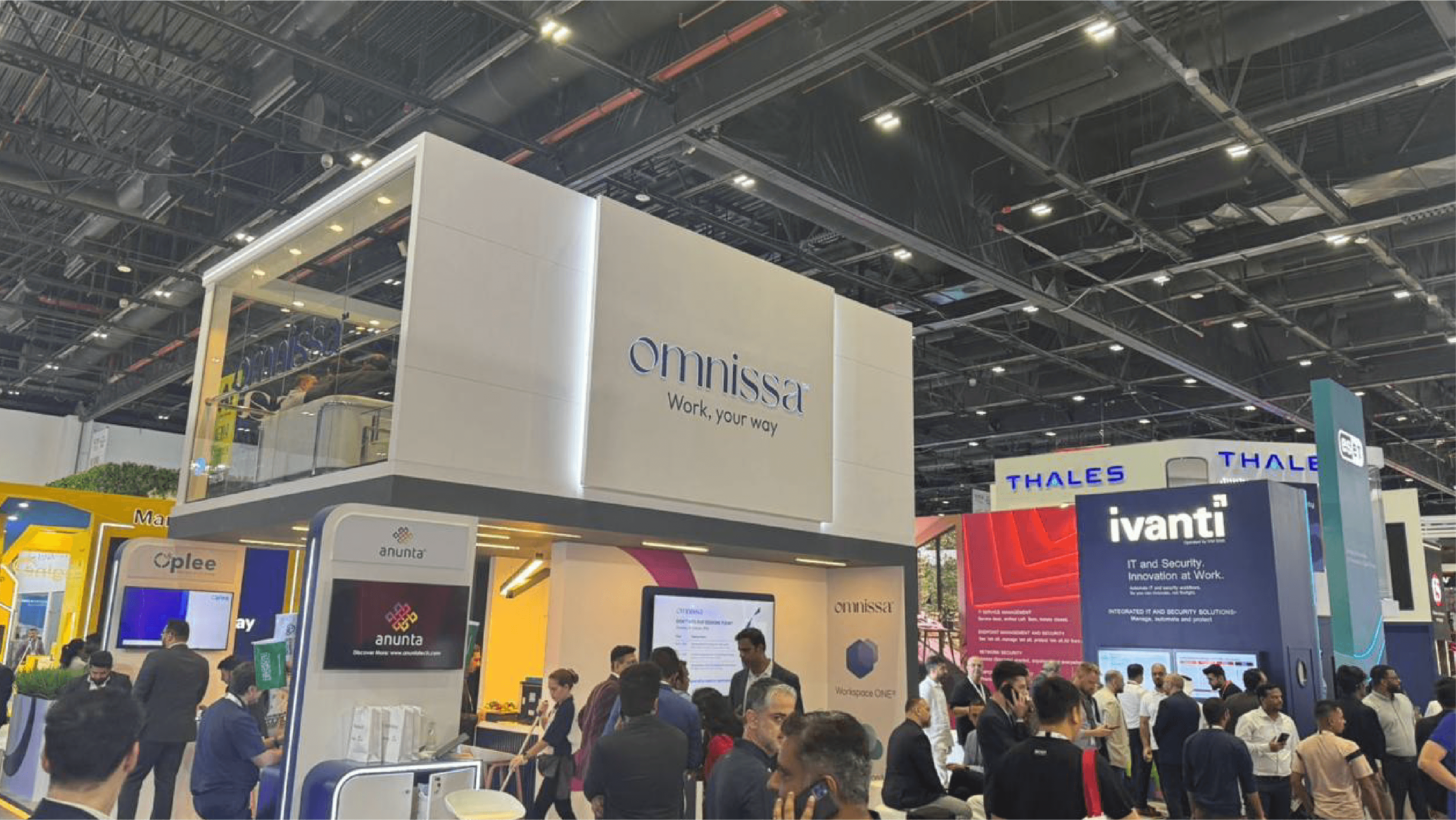 Omnissa exhibition booth at GITEX with branded architecture and attendees
